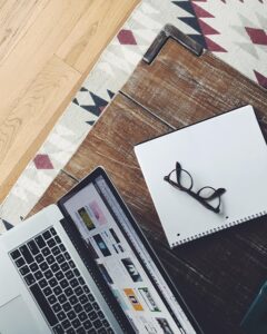 apple, eyeglasses, laptop, macbook, notebook, paper, wood