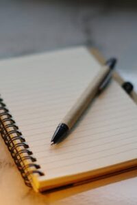 Close-up of a pen on a spiral notebook, perfect for writing or journaling concepts.